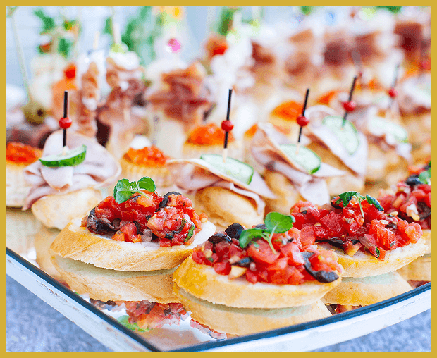 Assorted appetizers on a reflective tray.