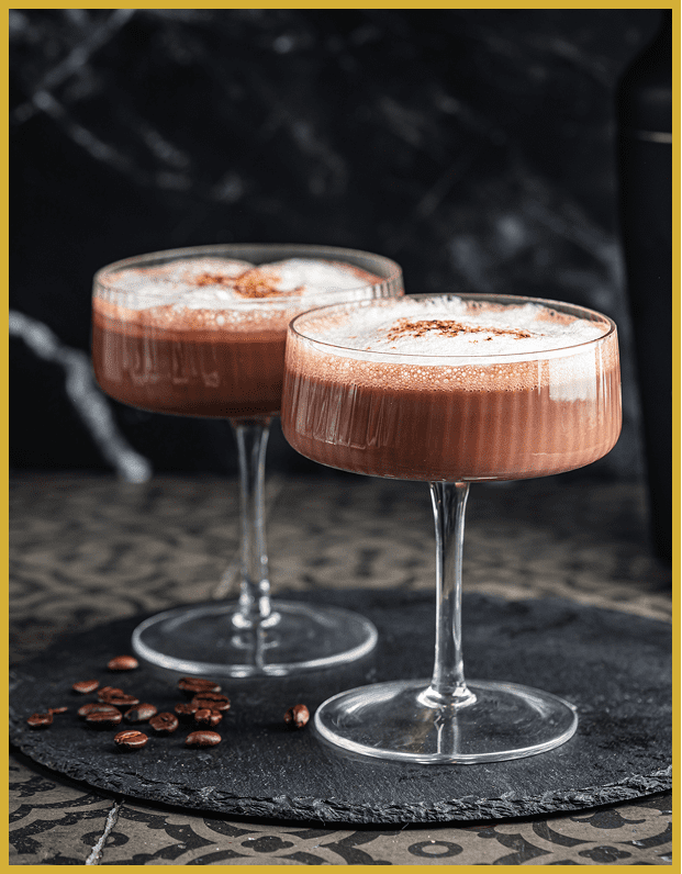 Two chocolate cocktails in elegant glasses.
